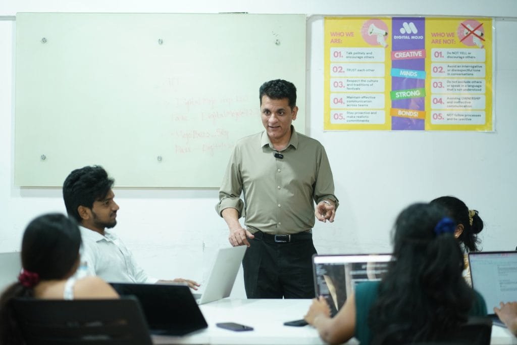 Digital Mojo team leader presenting creative strategy to employees in modern office meeting room