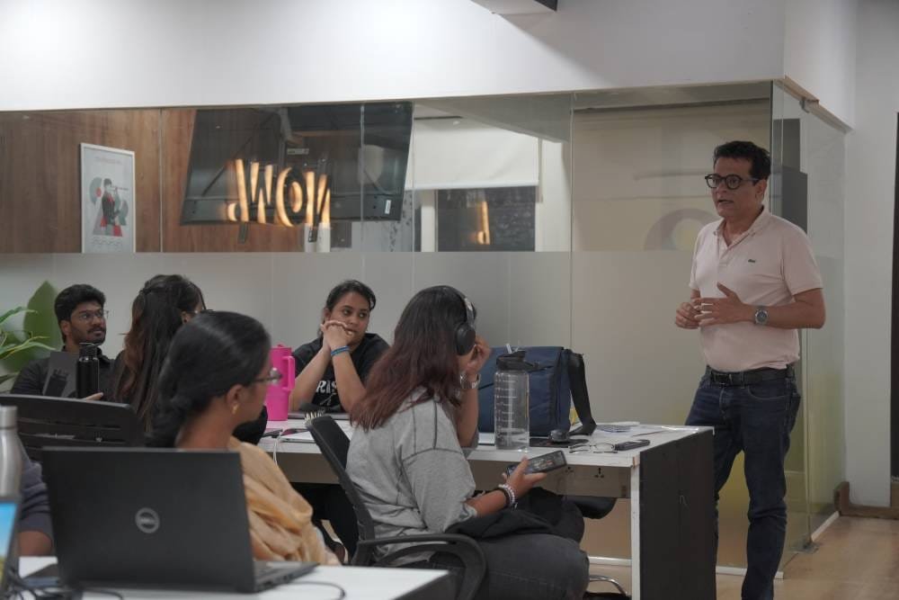 Digital marketing professional conducting training session with team members in modern office conference room