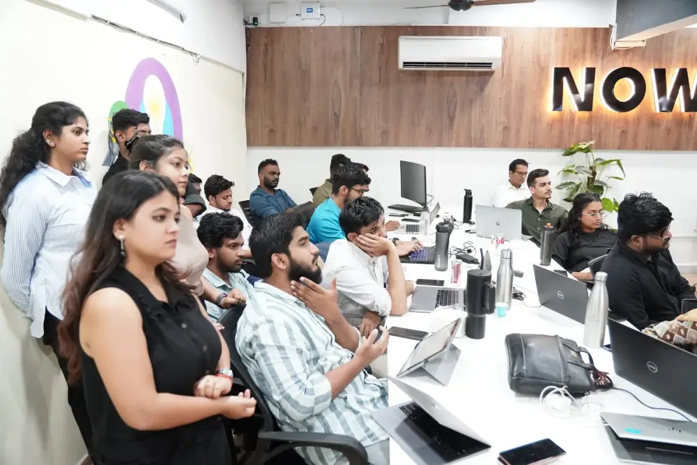 Digital Mojo team collaborating in modern office workspace with computers and collaborative setup