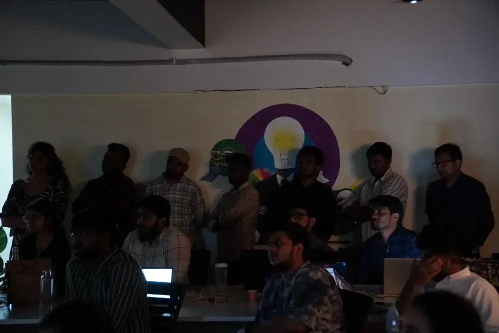 Team brainstorming session at Digital Mojo Hyderabad with creative lightbulb wall art