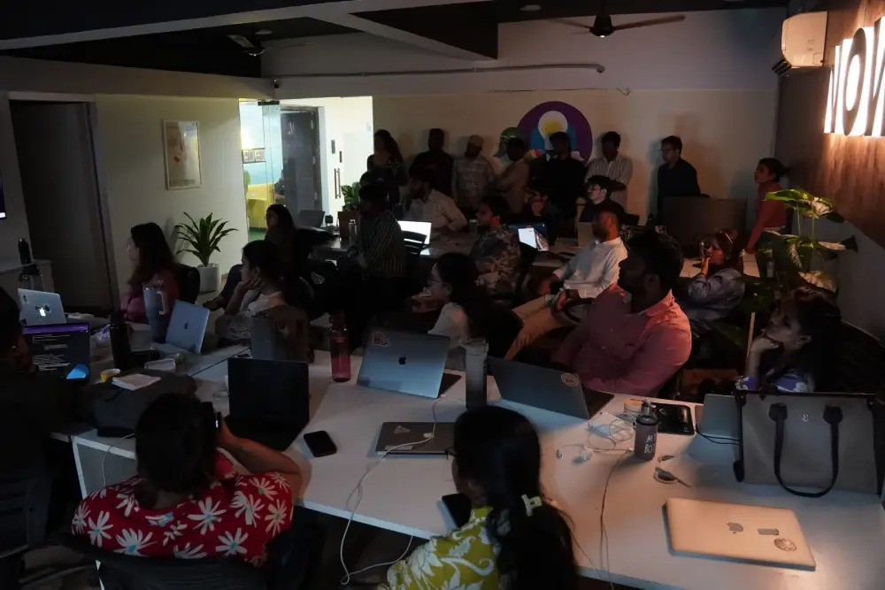 Professional team meeting at Digital Mojo Hyderabad office with diverse employees collaborating around workspace tables