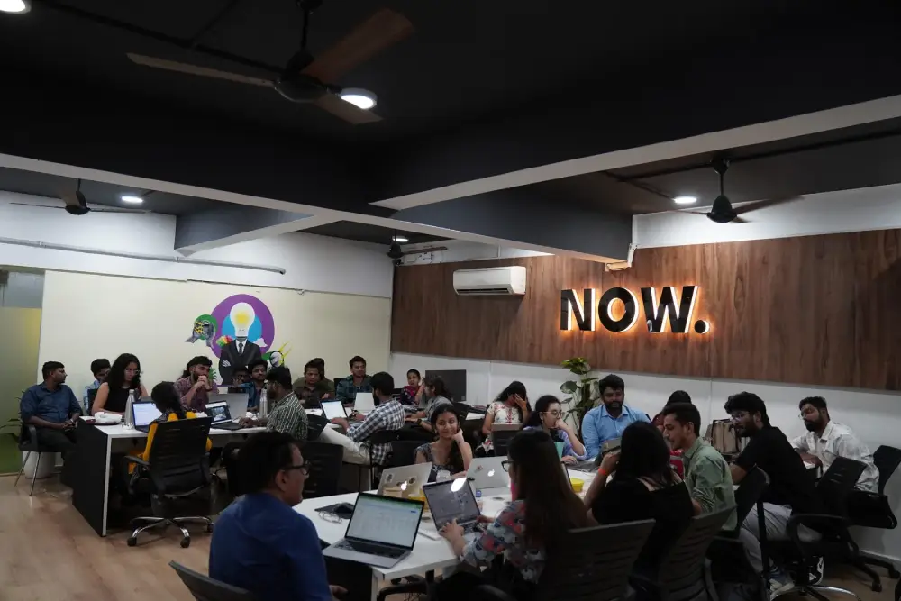 Digital marketing team collaboration meeting at NOW creative agency office in Hyderabad with laptops and brainstorming session