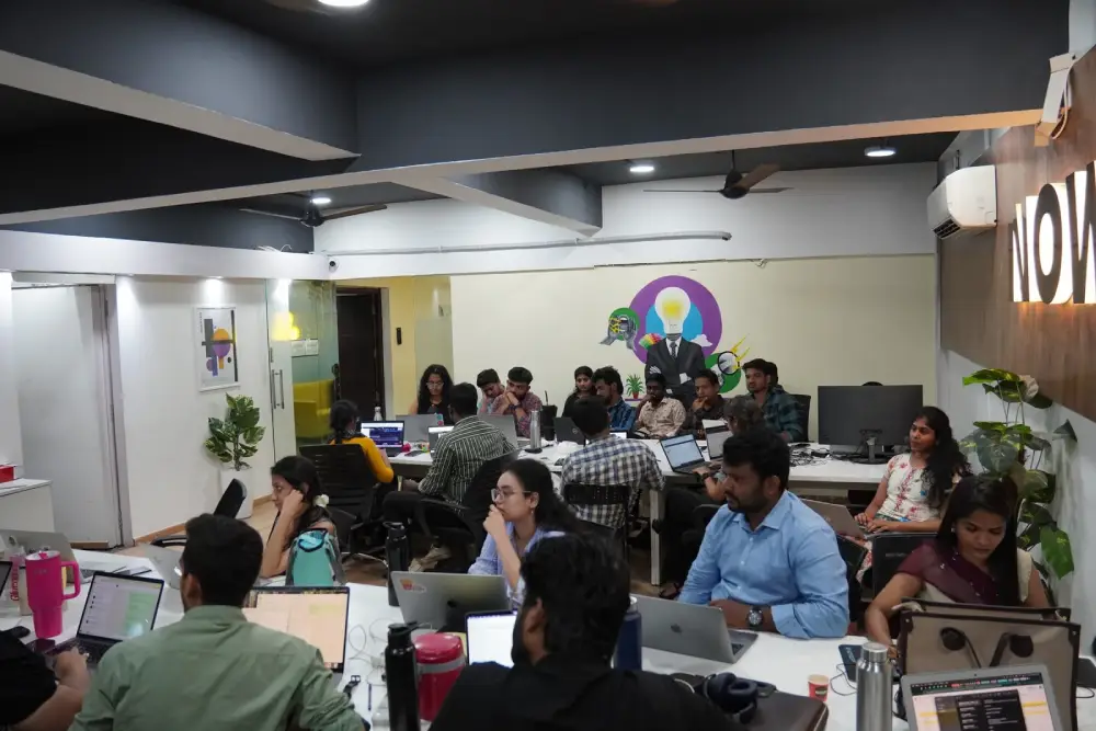 Digital Mojo team collaborating in modern office workspace with laptops and creative decor