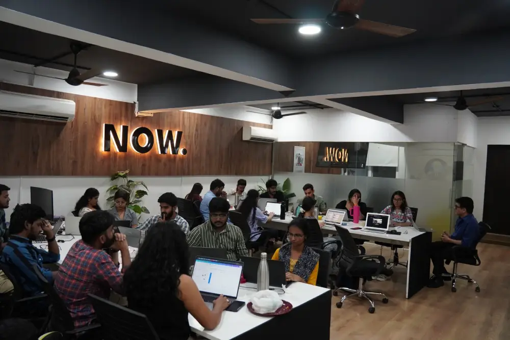 Modern collaborative workspace with diverse team working on laptops at Digital Mojo office in Hyderabad