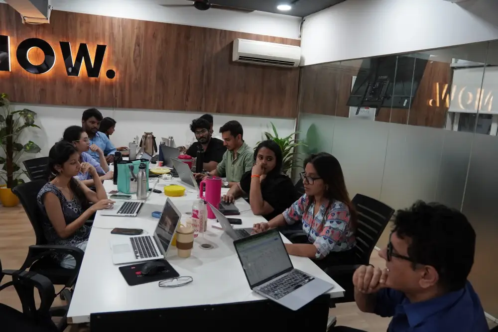 Digital marketing team collaboration meeting at Hyderabad office with laptops and brainstorming