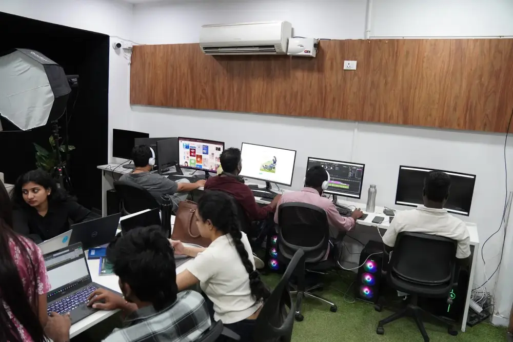 Digital marketing team working on creative projects in modern office space with multiple monitors and computers