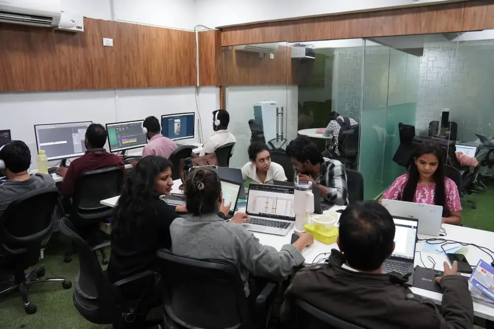 Digital marketing agency team collaborating on video editing and design projects in modern office workspace
