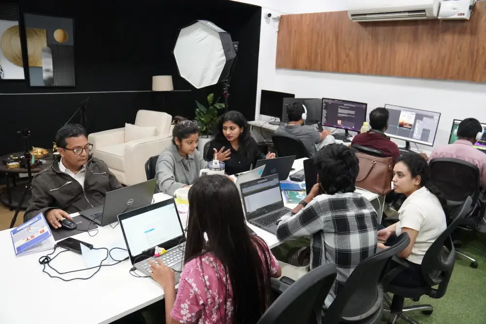 Digital marketing team collaborating in modern office with laptops and creative workspace setup