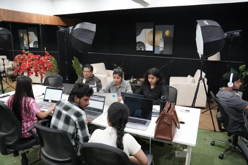 Digital marketing team collaborating in modern studio with laptops and professional lighting equipment