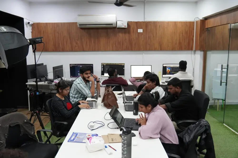 Digital marketing team collaborating in modern office workspace with computers and equipment