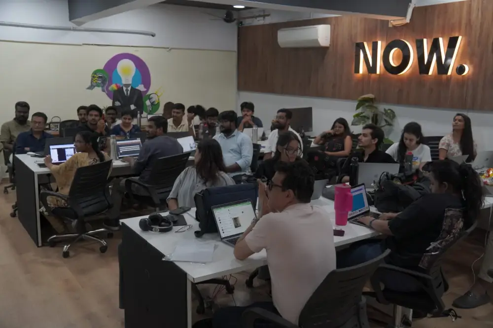 Digital marketing team collaboration meeting at NOW agency office in Hyderabad with laptops and creative workspace setup