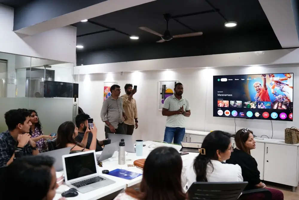 Digital marketing team training session in Hyderabad office with presenter and audience viewing streaming platform interface