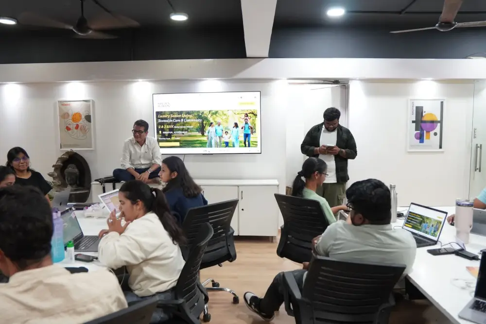 Digital marketing team collaboration in modern office with laptops and presentation screen