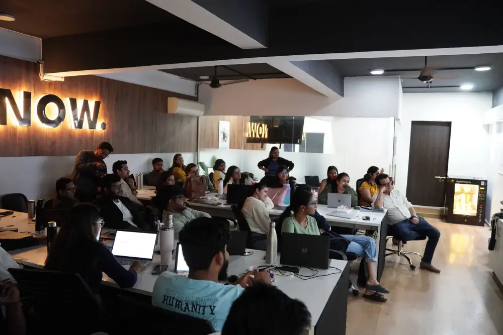 Digital marketing team meeting in modern office with laptops and collaborative workspace setup